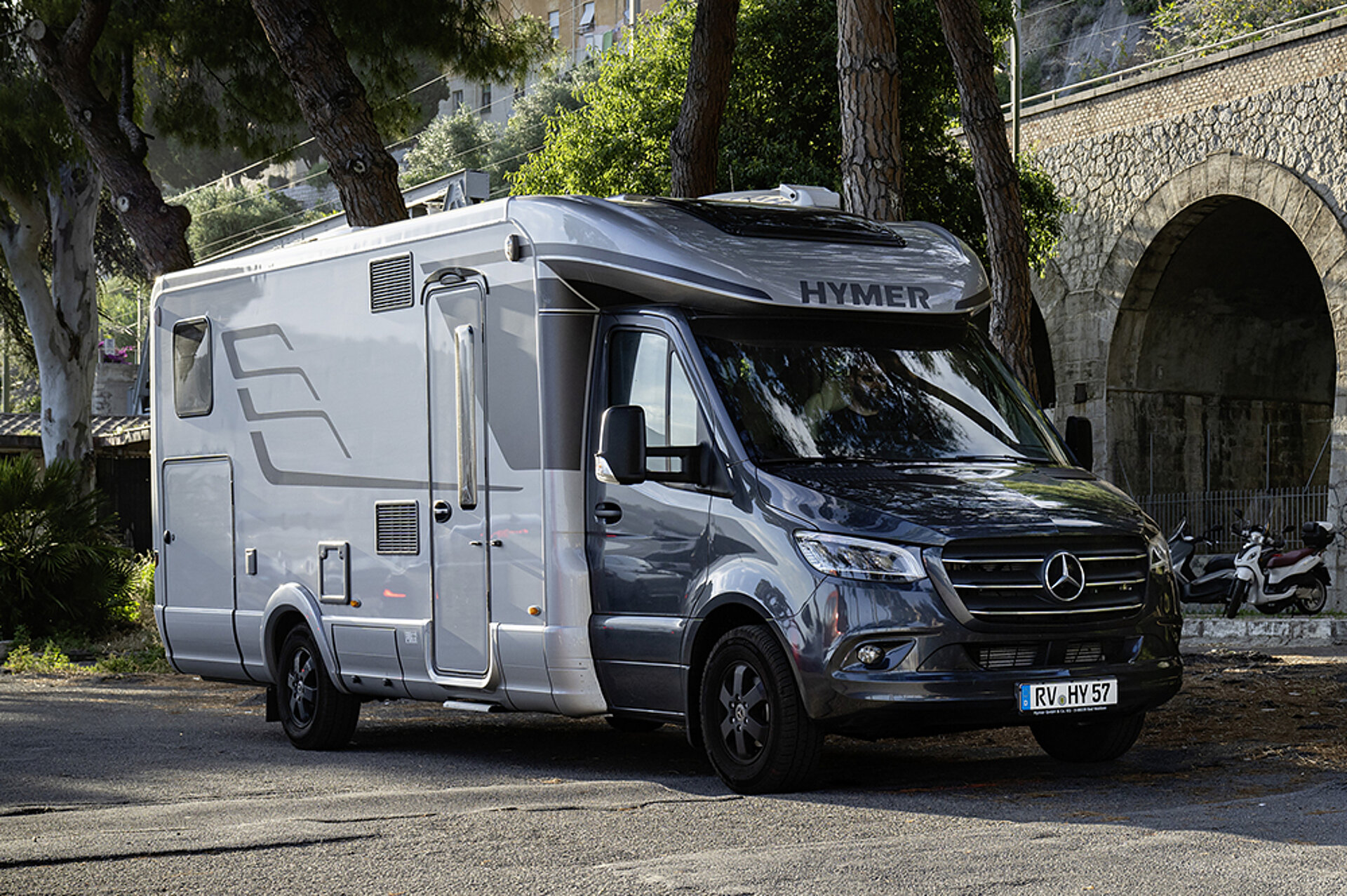 Erleben Sie integrierten Komfort im teilintegrierten Design. Ein teilintegrierter HYMER B-ML T steht an einem Straßenrand geparkt.