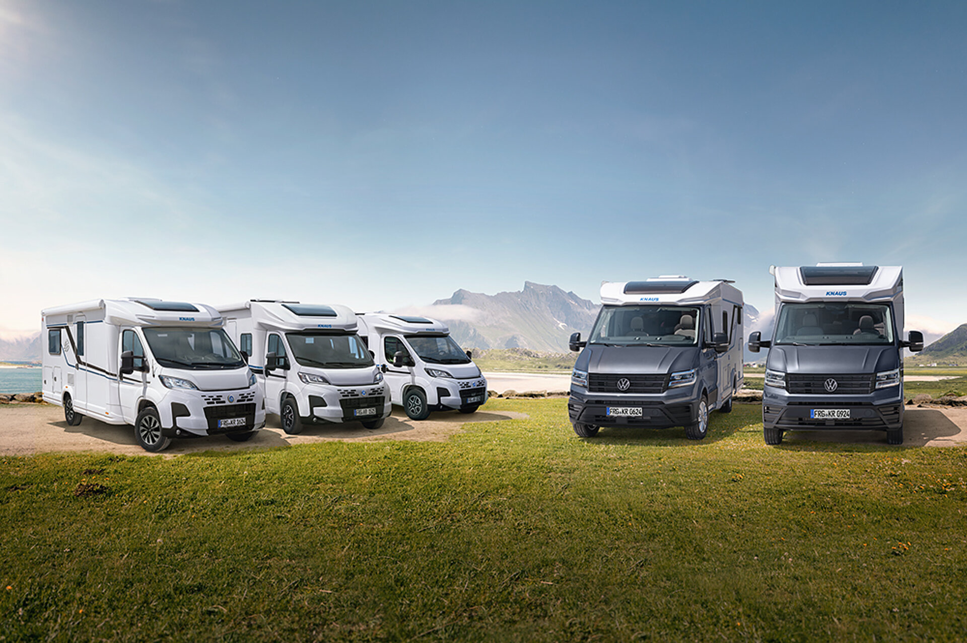 All of KNAUS' semi-integrated motorhomes are parked next to each other in a meadow.