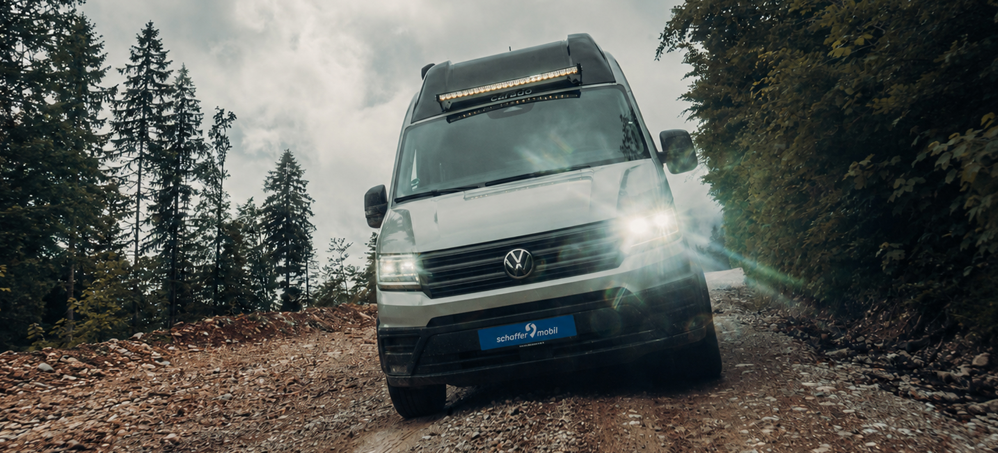 Ein Carado CV595 4×4 X-EDITION fährt über einen unwegsamen Waldweg.