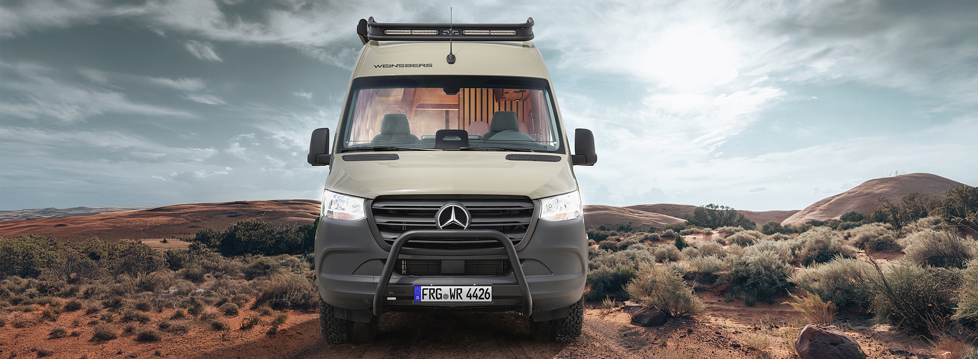 Použitý terénní dodávkový vůz stojí v poušti.